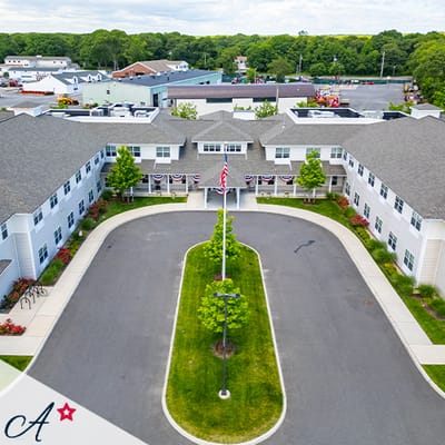 Aerial view of assisted living facility with landscaped grounds