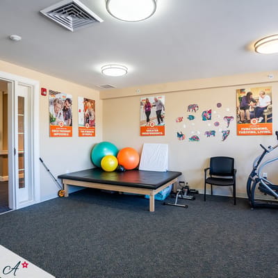 Interior activity room with fitness equipment and decor
