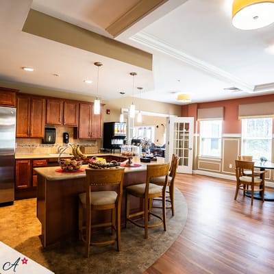 Bright kitchen area with seating and fruit display