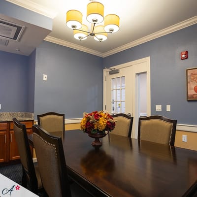 Interior dining room with a large table and decorative flowers