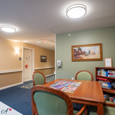 Common area with a table and games in a hallway