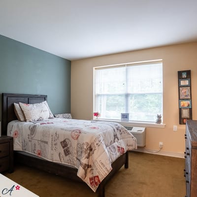 A well-furnished resident room with natural light