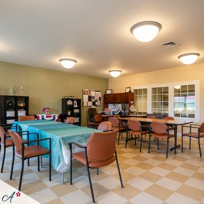 Bright activity room with tables and chairs