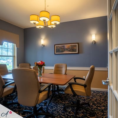 Meeting room with a chandelier and floral centerpiece