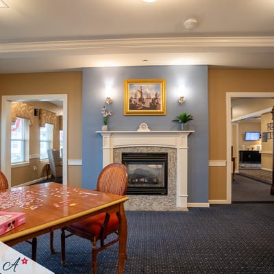 Interior common area with a fireplace and seating