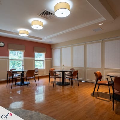 A bright common area with tables and chairs