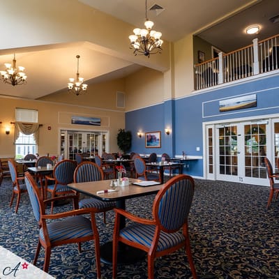 Well-furnished dining area with decorative chandeliers