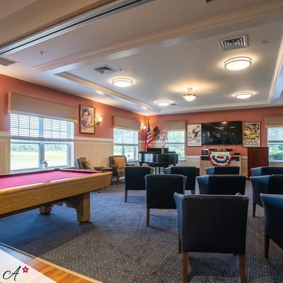 Interior view of a common area with seating and a pool table