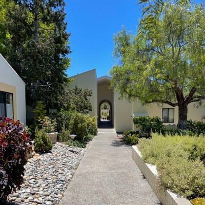 Pathway leading to a bright and welcoming entrance