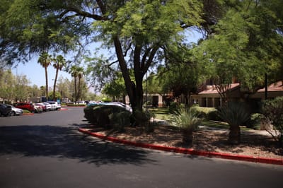 Outdoor view of the facility with trees and parking
