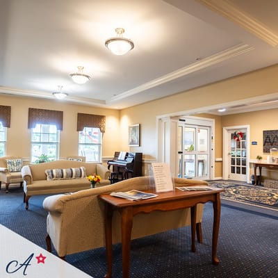 Bright interior common area with seating and piano