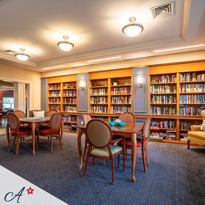 Interior view of a cozy library with bookshelves and tables