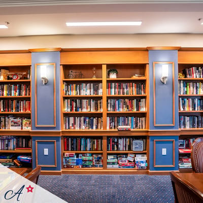 Bright interior library with bookshelves and games