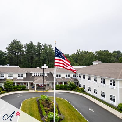 Exterior view of the facility with flag and entrance