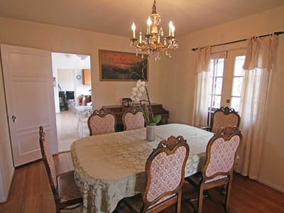 Elegant dining room with chandelier and large table.