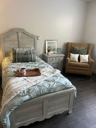 Cozy resident room with bed and chair