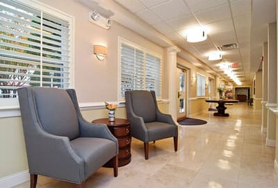 Bright hallway with chairs and table in a senior living facility