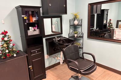 Interior view of a salon area with a chair and decorations