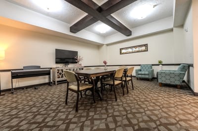 Bright common area with a dining table and seating