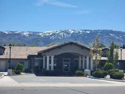 Exterior view of Stone Valley Memory Care facility with mountains