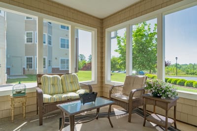 Sunlit sunroom area with comfortable seating