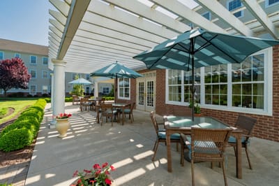 Outdoor garden area with tables and umbrellas
