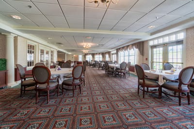 Interior view of a dining room with tables and chairs