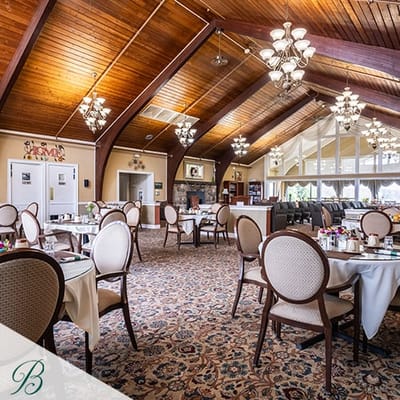Elegant dining room with chandeliers and floral carpet