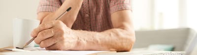 Close-up of a resident writing with a pen