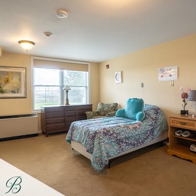 Cozy resident room with bed and seating area