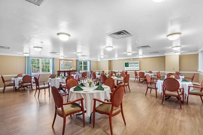 Dining area set up for residents with green napkins
