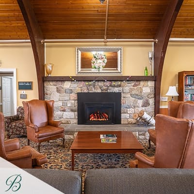 Cozy common area with stone fireplace and seating