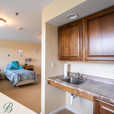 Interior view of a resident's room with kitchenette