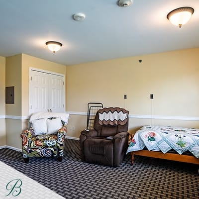 Private resident room with chair and bed