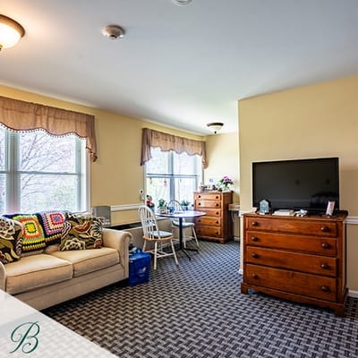 Cozy resident room with a couch and dresser