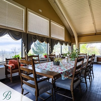 Bright common area with wooden dining table and views
