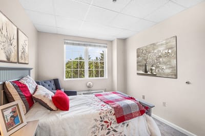 Cozy private resident room with floral decor and window view