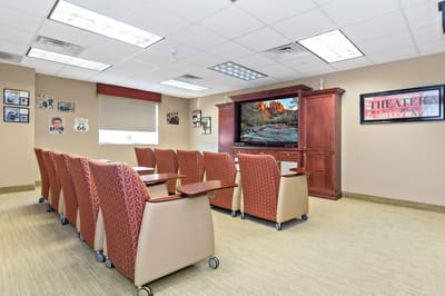 Interior common area with seating and a TV