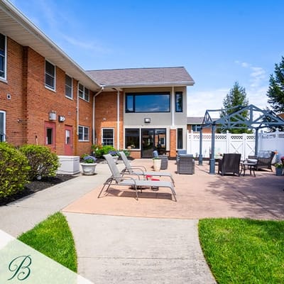 Outdoor patio area with seating and landscaping