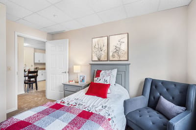 Cozy resident room with bed and chair