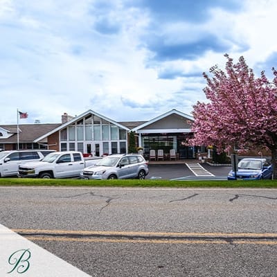 Exterior view of Bentley Assisted Living at Branchville with flowering trees