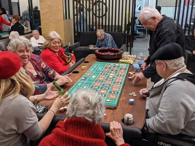 Residents enjoying a game of roulette in a common area