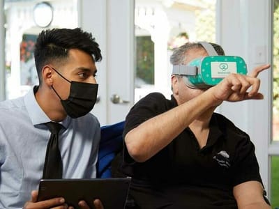 Residents engaging in virtual reality activity with staff