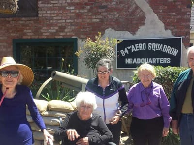 Group of residents enjoying time outdoors near a building