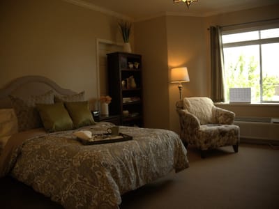 Cozy resident bedroom with a bed and armchair