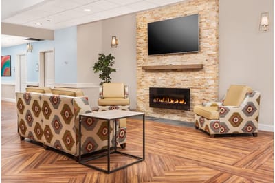 Common area with couches and fireplace in a nursing home