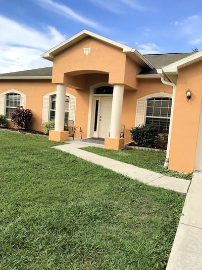 Exterior view of a senior living facility with orange walls