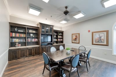 Interior view of a common area with bookshelves and a table