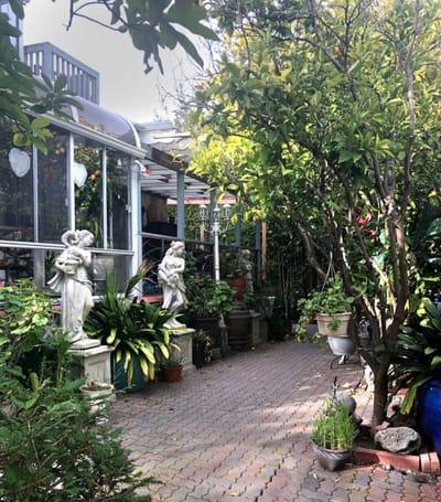 Pathway through a lush garden with sculptures