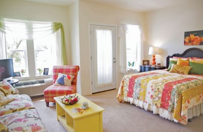 Well-decorated resident room with colorful bedding